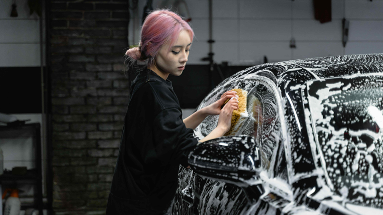 Girl cleaning car