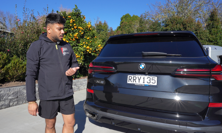 Jeet explaining a vehicle care recommendation to a customer in Auckland
